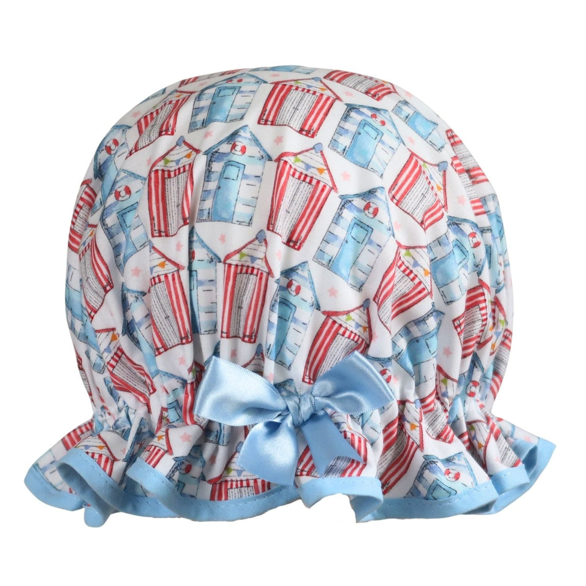 Vintage style women's roomy cotton shower cap featuring multi-coloured beach huts on a white background. Trimmed sea blue with matching satin bow.