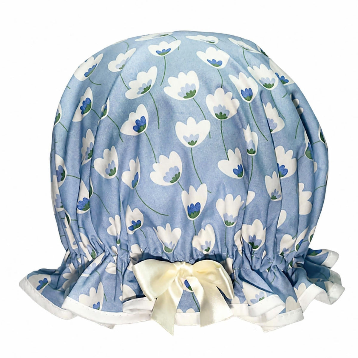 Vintage style women's roomy cotton shower cap. Frilled edge featuring cream tulip style flowers on a grey blue background. Trimmed in cream with matching satin bow.