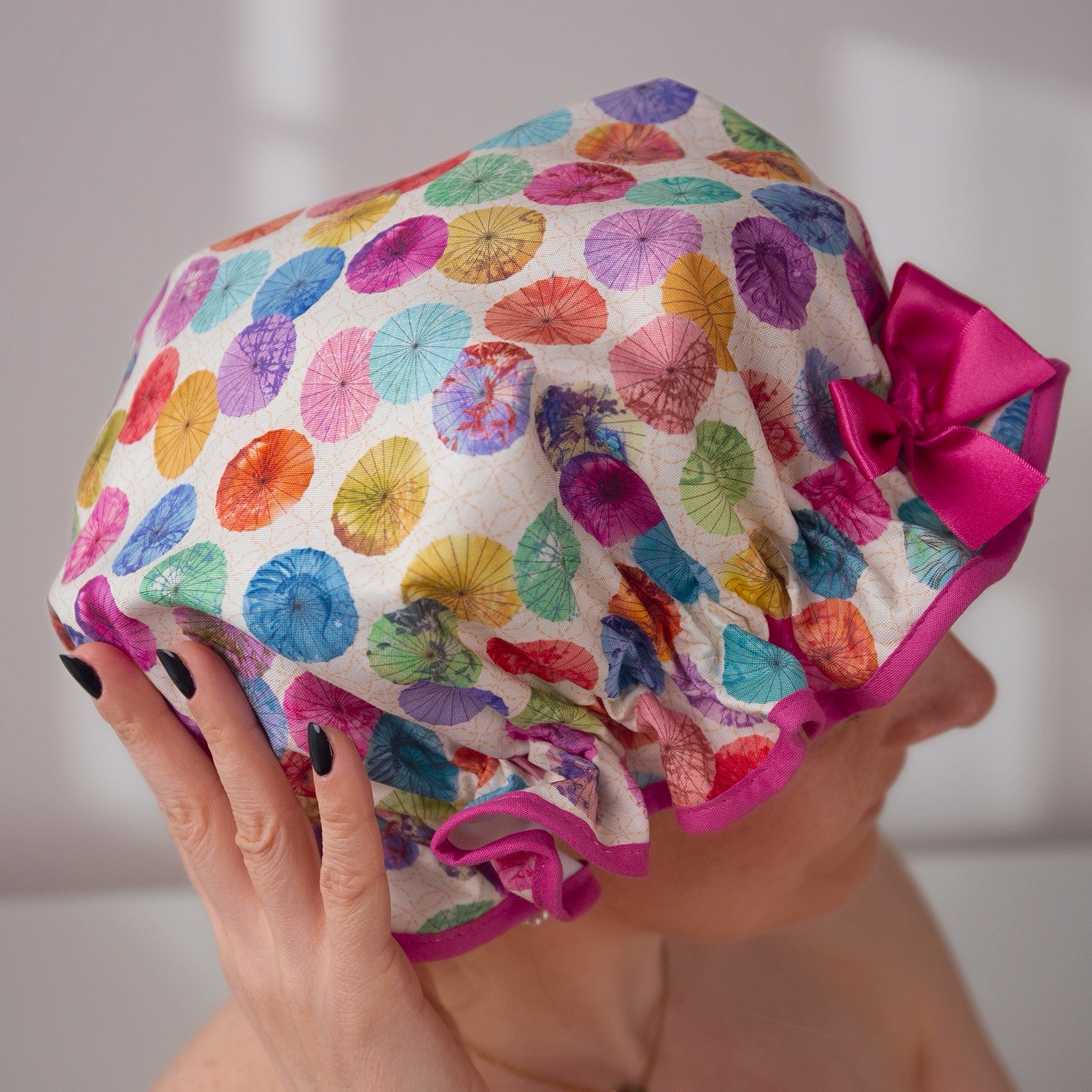 Vintage style, women's large cotton shower cap. Frilled edge, multi-coloured parasol print trimmed in warm pink and matching satin bow.