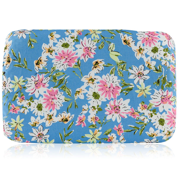 Soft waterproof rectangular bath pillow covered in a summer flowers print in green, white and pink, with sky-blue background.  Two suckers on reverse.