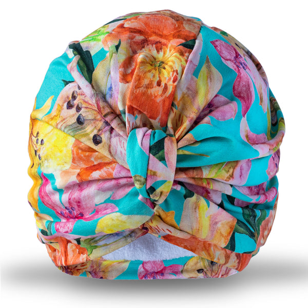 Bright multicoloured floral jersey pull on towelling lined turban, with pretty gather and knot at front