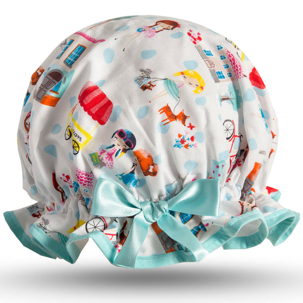 Vintage style women's large cotton shower cap.  Frilled edge, colourful Parisian style print of women walking little dogs, cycling, ice cream cars, houses and trees on a white background with aqua trim and bow.