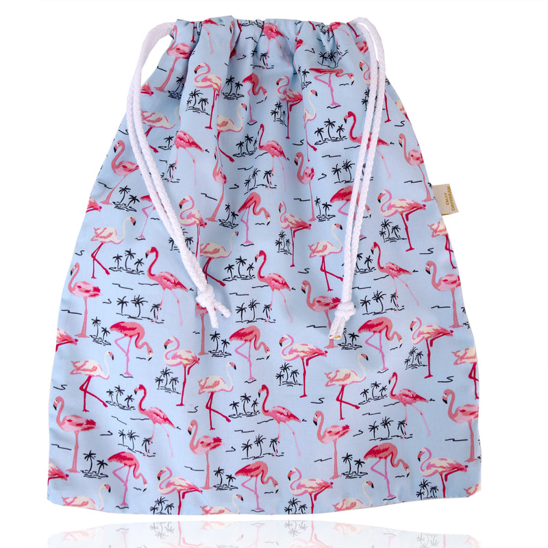 Flat pink and blue flamingo cotton print wash bag with white cord pulls and white waterproof lining
