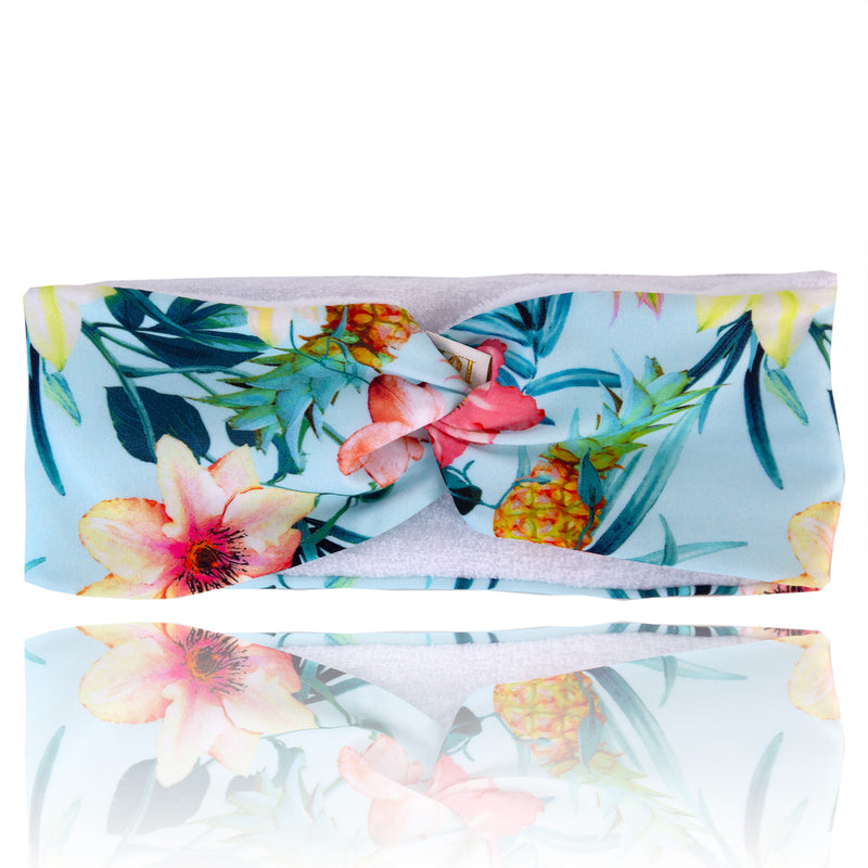 Multicoloured tropical print hairband, with white microfibre lining, with twist at top.
