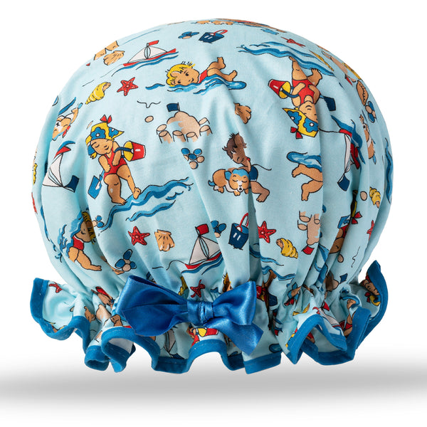 Vintage style women's large cotton shower cap.  Frilled edge, cute chubby children swimming and playing on the beach print, on a blue background with matching trim and  satin bow.