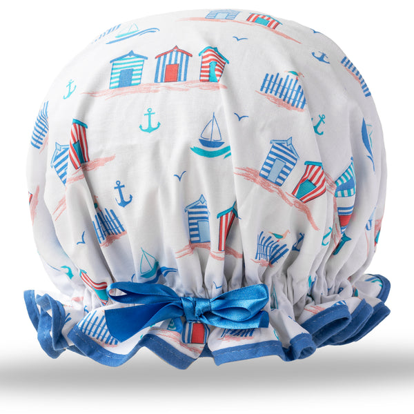 Vintage style women's large cotton shower cap.  Frilled edge, fun beach hut  print in reds and blues on white background. Matching blue trim and satin bow.
