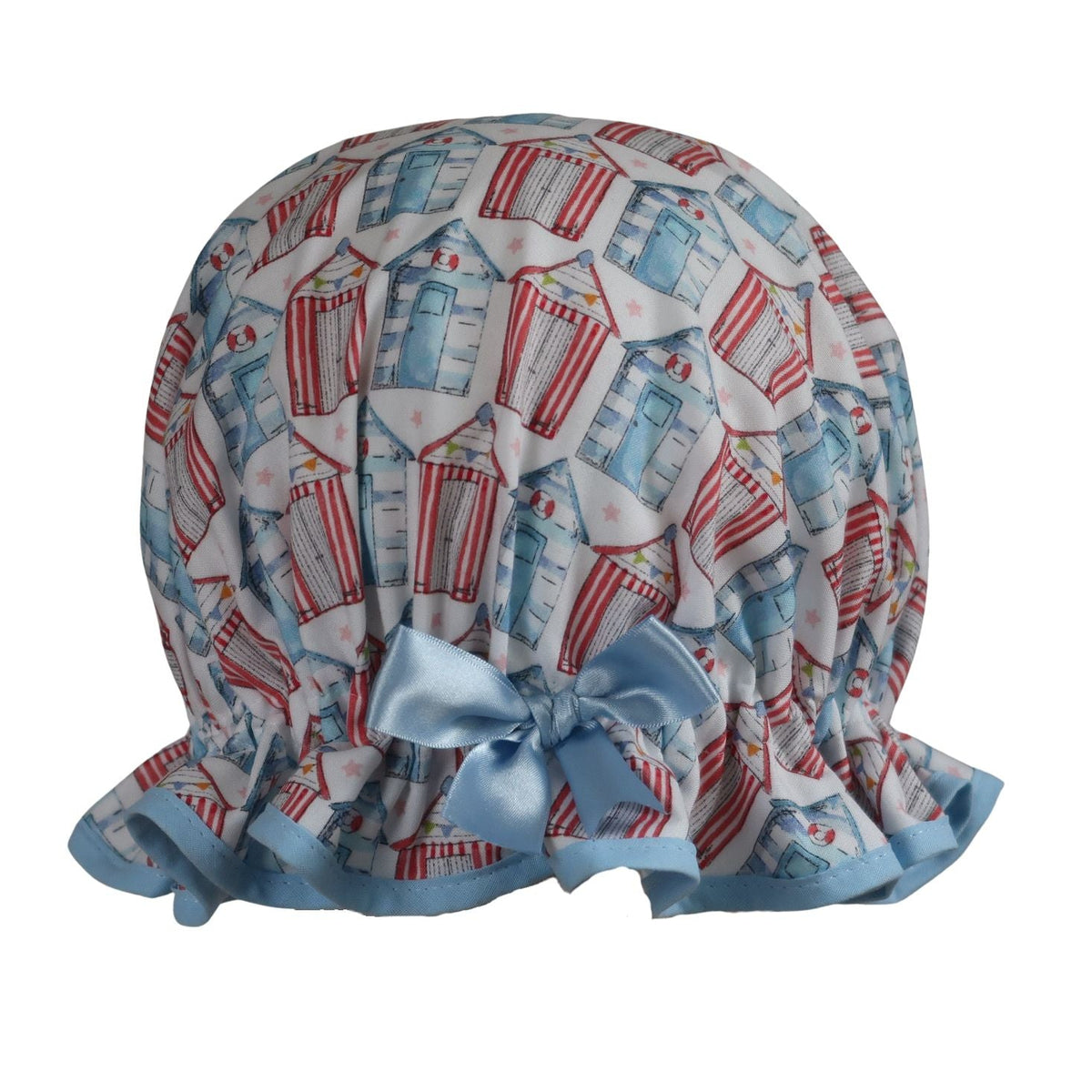 Vintage style women's roomy cotton shower cap featuring multi-coloured beach huts on a white background. Trimmed sea blue with matching satin bow.
