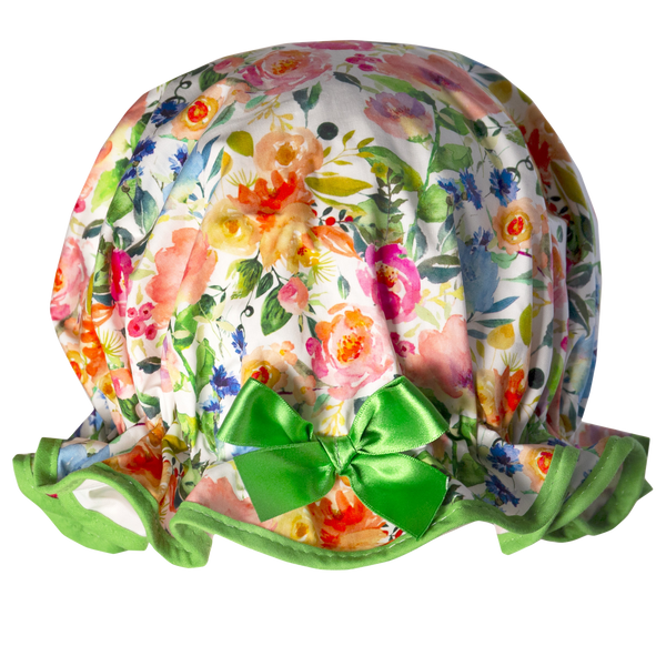Vintage style, women's large cottn shower cap.  Frilled edge, bold & bright flower print in pinks greens and blues on a white background. Trimmed in a vibrant green with matching satin bow.
