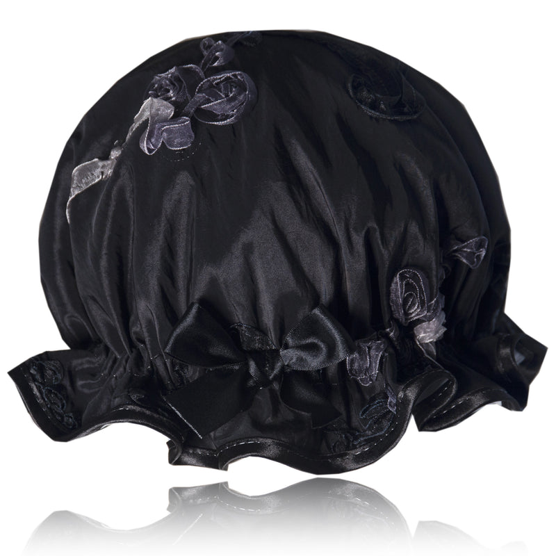 Vintage style women's shower cap.  Swirls of white, silver and black ribbons on a black background.  Trimmed in black with matching satin bow.