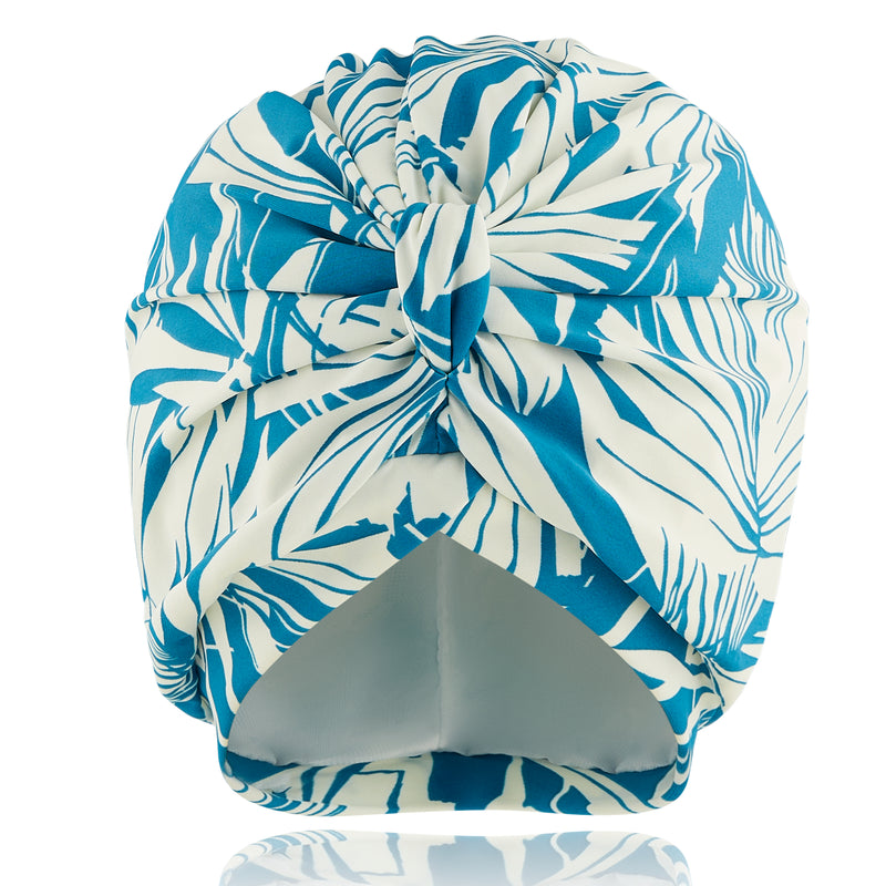 Blue and white palm stretch lycra print pull on bamboo jersey lined turban, with pretty gathered knot at front

