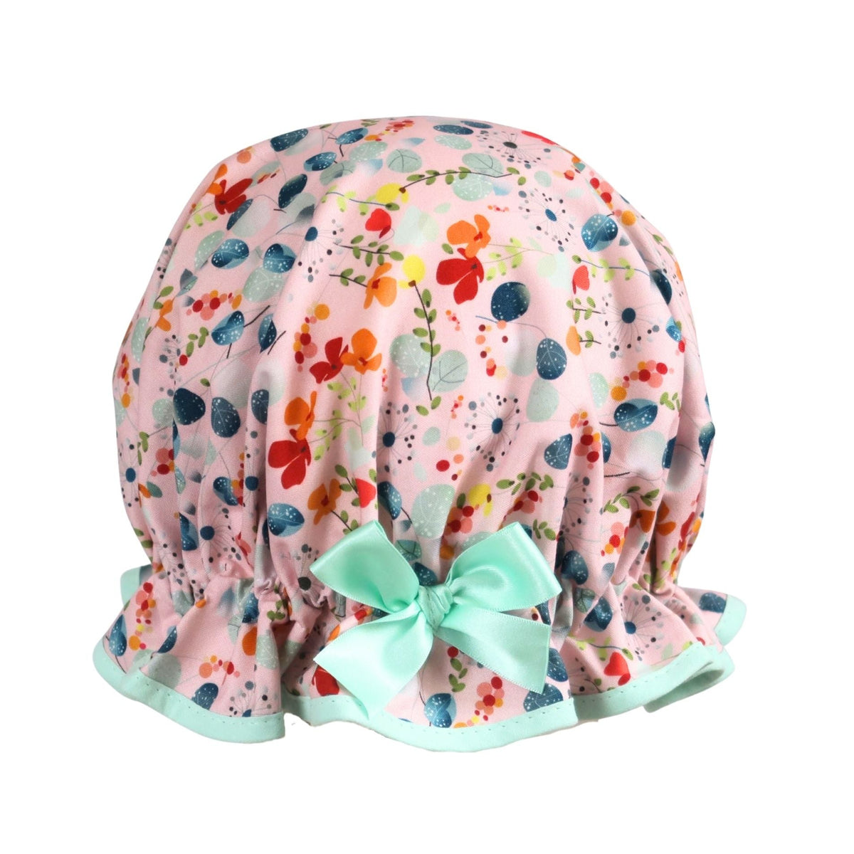 Vintage style women's roomy cotton shower cap.  Frilled edge, grey blue eucalyptus, dandelions, orange and red flowers on a pink background. Trimmed in mint with complementary aqua bow.