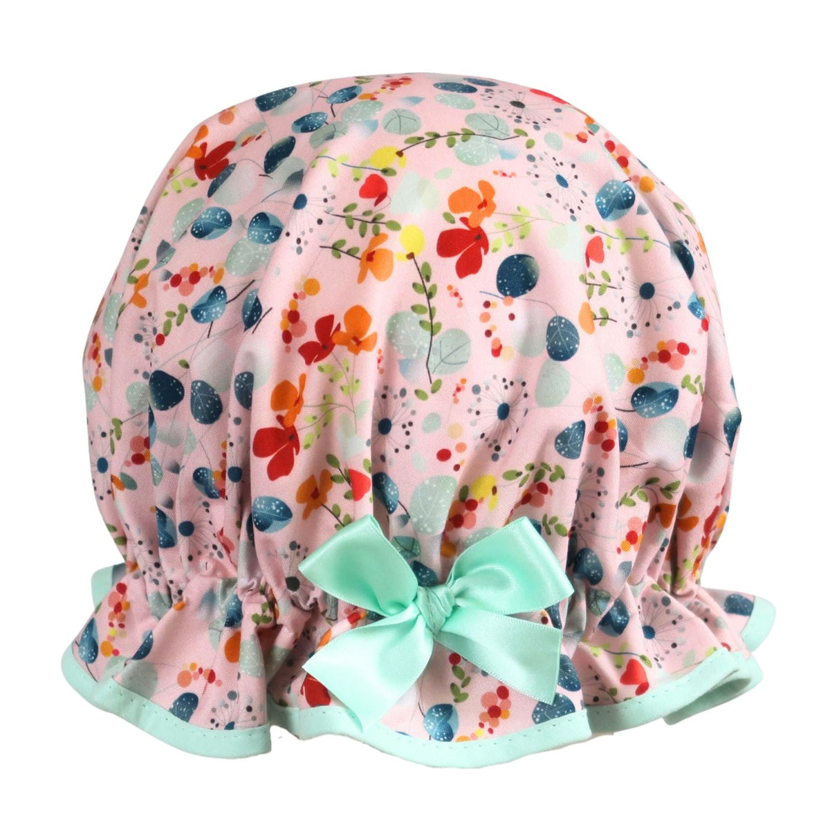 Vintage style women's roomy cotton shower cap.  Frilled edge, grey blue eucalyptus, dandelions, orange and red flowers on a pink background. Trimmed in mint with complementary aqua bow.