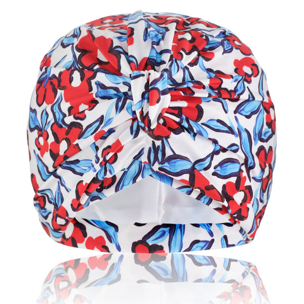 Red and blue stretch lycra floral print pull on bamboo jersey lined turban, with pretty gathered knot at front