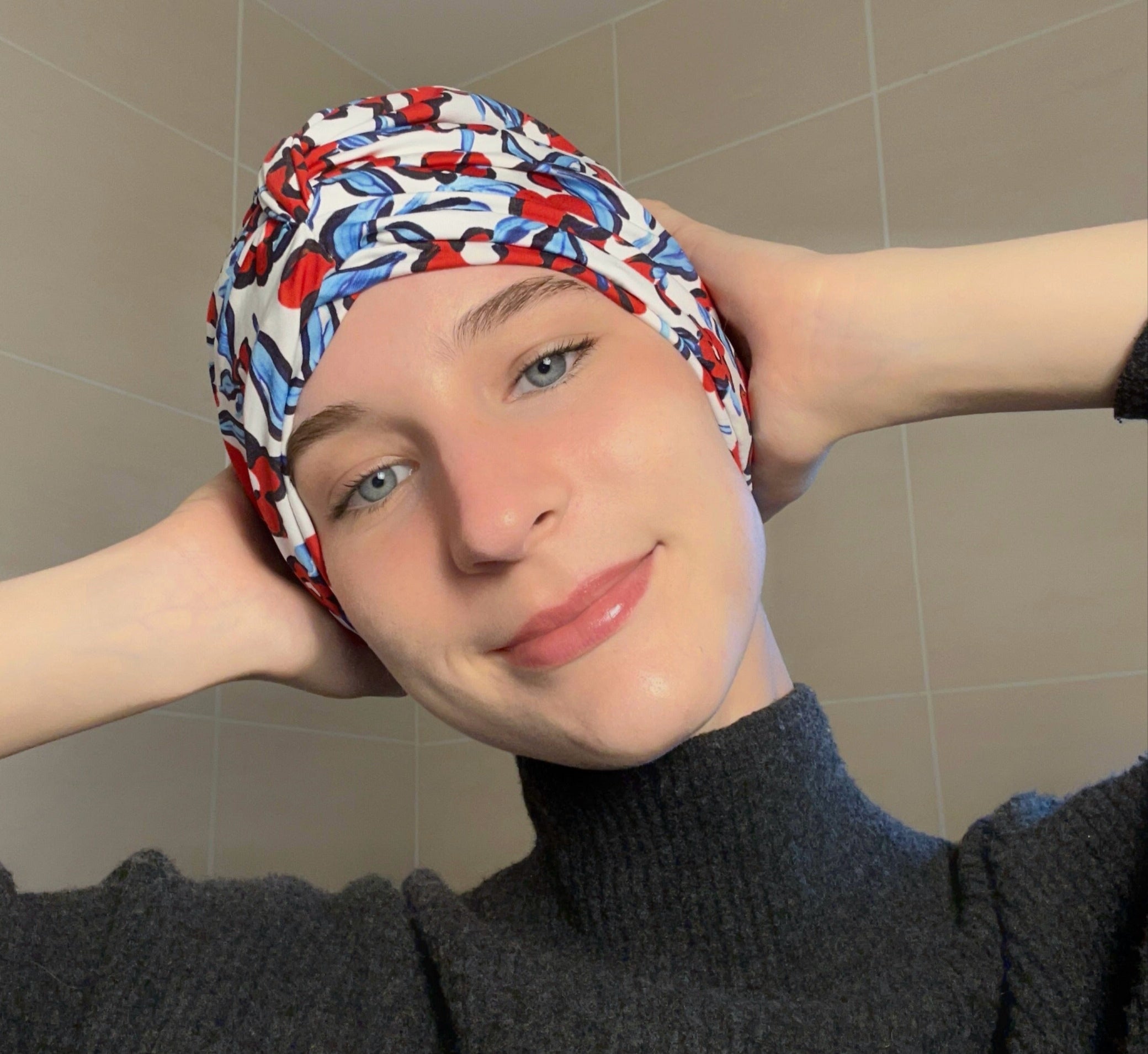 Woman wearing a colourful blue and red floral patterned drying turban