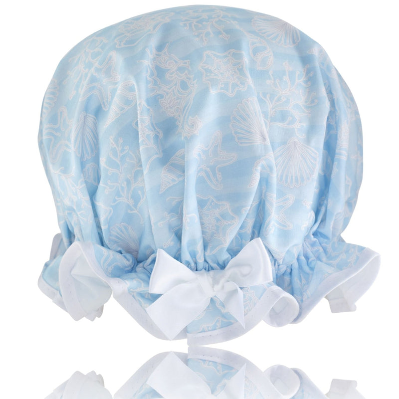 Vintage style women's large cotton shower cap.  Frilled edge, white sea plants, starfish and seahorses on a crisp blue background. Complementary white trim and satin bow.