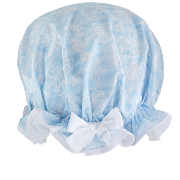Vintage style women's large cotton shower cap.  Frilled edge, white sea plants, starfish and seahorses on a crisp blue background. Complementary white trim and satin bow.