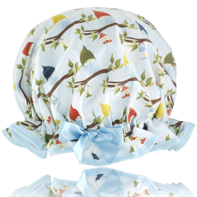 Vintage style, women's large cotton shower cap.  Frilled edge, multicoloured owl print in blue, green, brown and yellow. Trimmed in pale blue with matching satin bow.