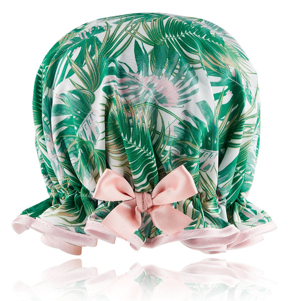 Retro style woman's frilled style shower cap.  Satin print of palm leaves in green and pink hues, with pale pink trim and satin bow.