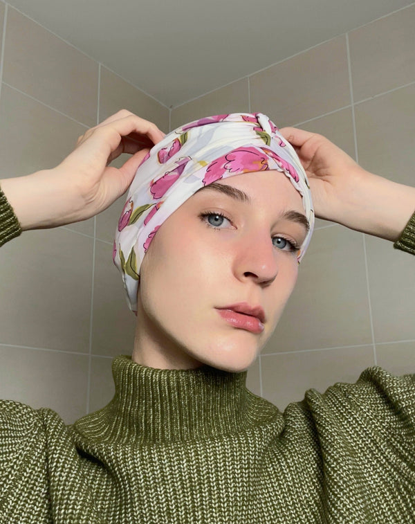 Woman wearing a tulip print drying turban 