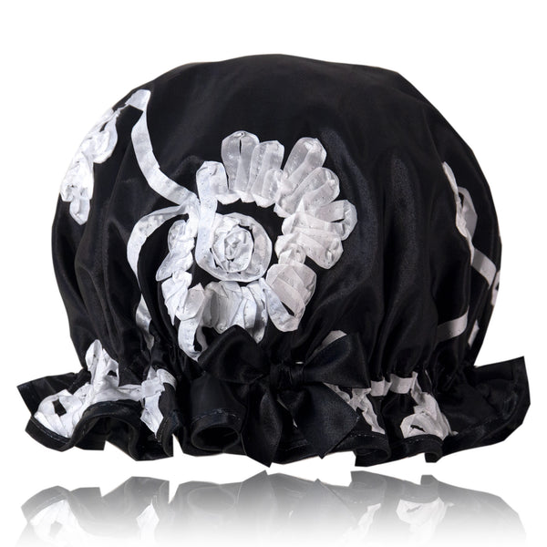 Vintage style women's shower cap.  Swirls of white ribbons on a black background.  Trimmed in black with matching satin bow.
