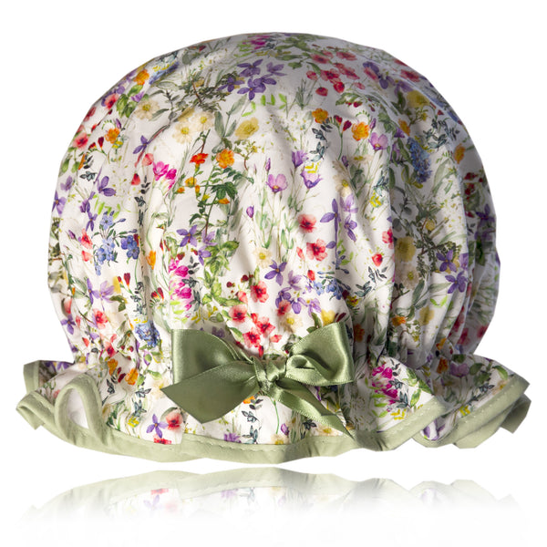 Vintage style, women’s large cotton shower cap. Frilled edge, multicoloured meadow floral print on a white background.  Trimmed in sage green with matching satin bow.