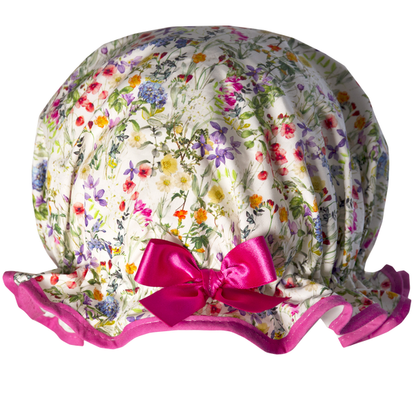 Vintage style, women’s large cotton shower cap. Frilled edge, multicoloured meadow floral print on a white background.  Trimmed in cerise with matching satin bow.
