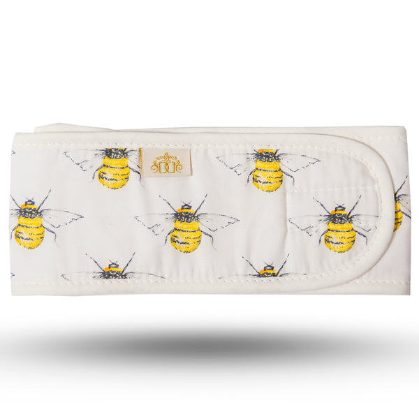 Symmetric bee print cotton hairband on ivory background with ivory trim and white microfibre lining.  Velcro closure strip.
