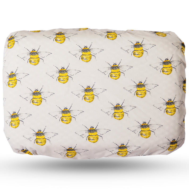 Soft waterproof rectangular bath pillow covered in a bee cotton print on ivory background.  Suckers on reverse.