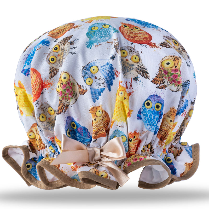Vintage style, women's large cotton shower cap.  Frilled edge, multicoloured owl print in blue, brown and yellow. Trimmed in stone with matching satin bow.