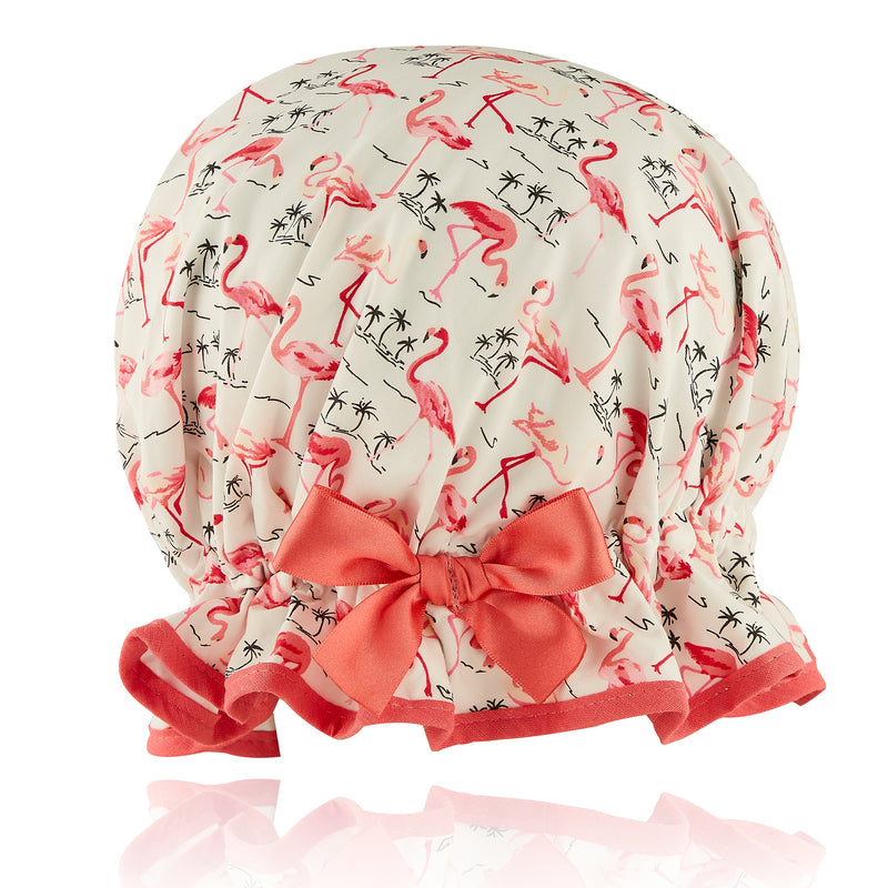 Vintage style women's large cotton shower cap.  Frilled edge, pink flamingos with small black palm tree outline on ivory background.  Coral trim and matching satin bow.