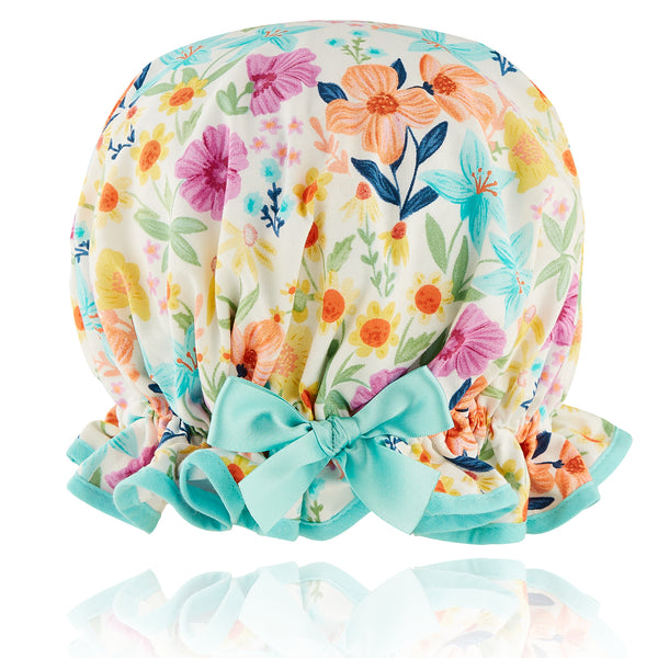 Vintage style women's large cotton shower cap.  Frilled edge, multi coloured flowers in orange, lilac, blue green and yellow printon white background  trimmed in aqua with matching satin bow.